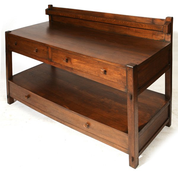 CONTEMPORARY GUSTAV STICKLEY SERVER: As illustrated Page 34 of Collectors Works. Oak, original finish mortised and pinned with plate rail, two drawers over shelf over one drawer. 24" x 60" x 44" high.