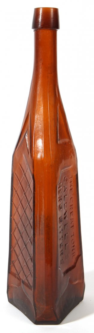 Caldwells Herb Bitters Bottle: In deep amber, three sided with recessed panels, one of which has molded lettering reading, “The Great Tonic/Caldwells/Herb Bitters," with graphite pontil and applied lip, 12.7” high.