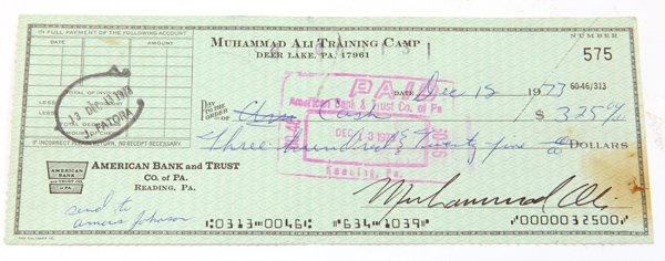 Muhammad Ali Autographed Check: Partially printed check from the “Muhammad Ali Training Camp, Deer Lake, Pa.” for $325 cash dated Dec. 15, 1977 and signed lower right in bold black ink with penned note lower left reading “send