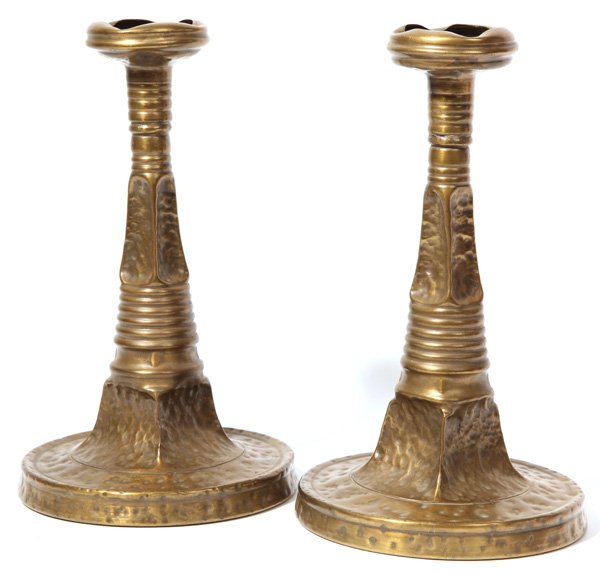 Pair of Apollo Studios, NY Arts and Crafts Candlesticks: Pair of hammered copper candlesticks with brass finish, marked, "Apollo Studios, New York," and numbered, "407." Original patina. 9 1/2" H x 5 1/2" Dia.