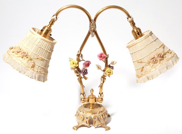 Edwardian Brass & Porcelain Dresser Lamp: With double ribbed goose necks with brass vine and leaves wrapping around posts with yellow, rose and purple porcelain roses attached to the vines, mounted on an open work cast brass base in Art Nouve