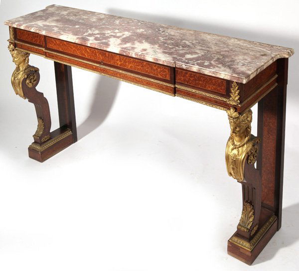 Louis XVI Ormolu Mounted Console Table: 19th century with mottled and shaped marble top, base in ebony and oyster wood with satin wood and ebony sting inlay. the gilt bronze ormalu mounts are exceptional with female masks on front columns,