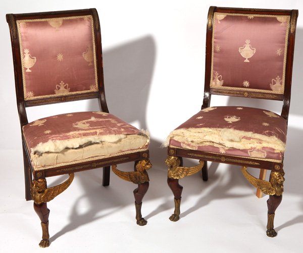 Pair of Louis XVI Ormolu Mounted Chairs: In mahogany, mid 19th century with original silk upholstery, wonderful winged griffin bronze mounts at top of legs and lion paw bronze feet, with floral bronze ormalu on sides and back. 21" wide seat 