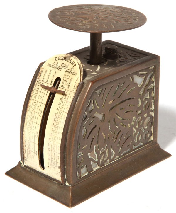 L.C. Tiffany Postage Scale: In Grapevine pattern with brass over glass and printed cello dial on curved front, in original patina, marked on base "Tiffany Studios/New York/872." 1.8" x 3" x 3.25" high.