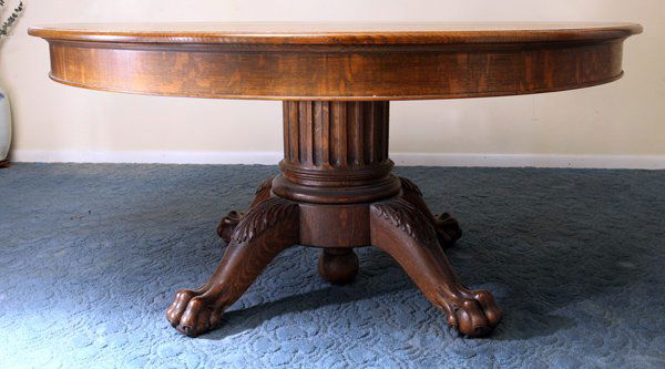 Super Round Oak Claw Foot Dining Table: 60" diamter top with five 12" wide leaves in original storage case. Table extending with all leaves would be 60" x 120." The large column is fluted and on four cabriole legs with acanthus carved knees