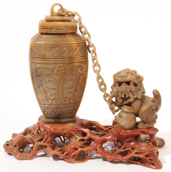 Carved Stone Chinese Urn & Lion: In tan soapstone with carved chain attaching lid to Foo lion, both resting on very intricately carved root form base in rust colored soap stone, some of the best carving one will see on early soapston