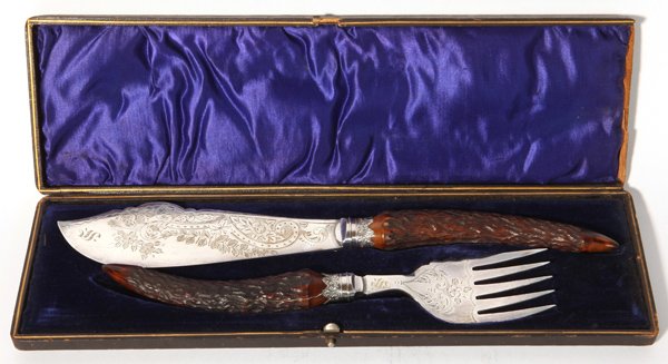 Cased Antler Handled Fish Set: In silver plate, circa 1870's with engraved floral scroll work, knife is 13.25" long and fork is 10.25" long. The fitted case is leather covered wood with silk and satin liner, 14.5 x 4.5 x 1.25" high