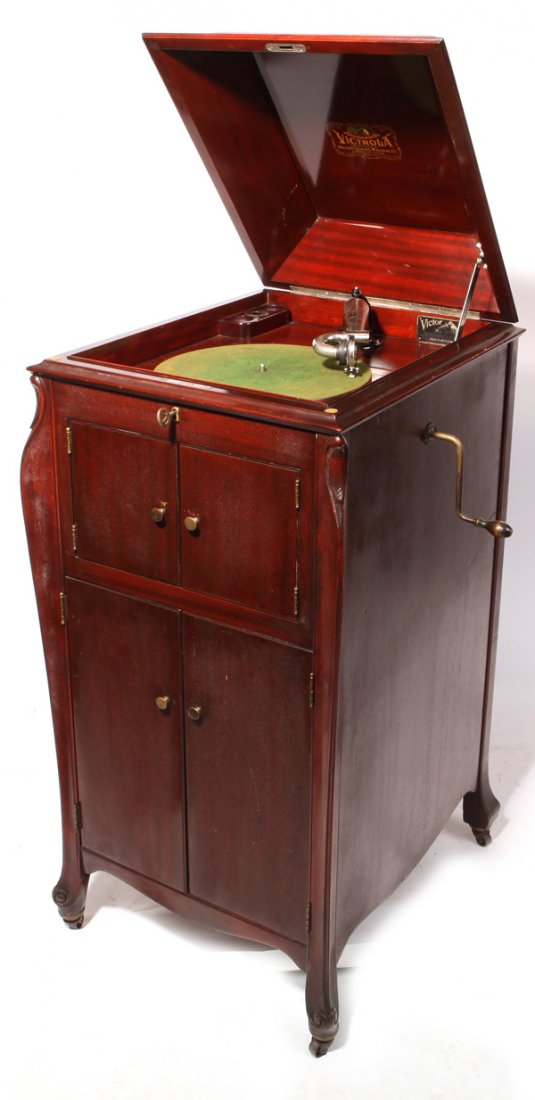 Victor Upright Phonograph: Victor VV-XI upright phonograph with original Victor Exhibition reproducer. Four door Mahogany case in fine original finish and condition, with original Victor key. 45" H x 20" W x 23" D.