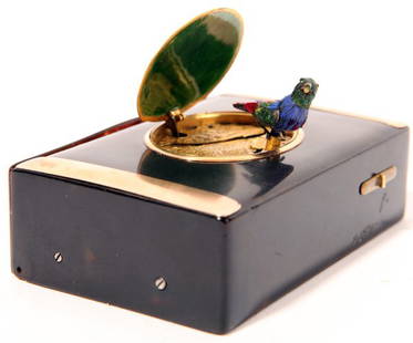 Swiss Singing Automaton Bird Box: Â Tortoise shell with rose gold bands, intaglio cut oval lid with gilt highlights, opens to reveal singing feathered bird which turns, opens beak, and flaps wings. Â Hinged rear door for storage o