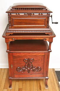 Regina 15 1/2" Disc Music Box & Stand: Wonderful double comb music box in mahogany case with cupola top and carved pillars at each corner. 32 discs. Â 13" H x 22 1/2" W x 20" D. Â Stand, mahogany with one carved door that is fitted wit