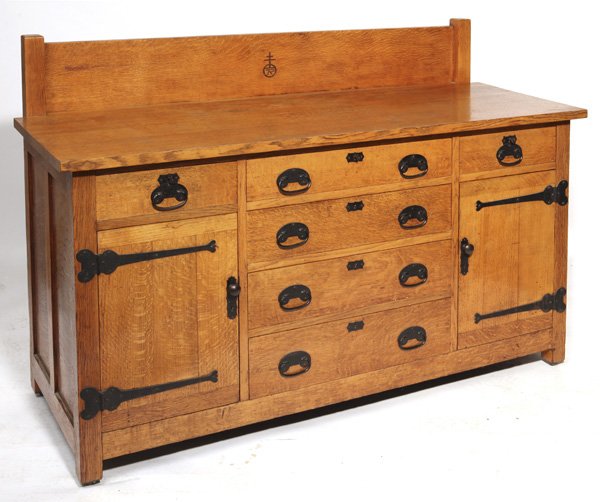 Roycroft Sideboard No. 02: Oak, with back splash and 3 drawers over 3 drawers and 2 doors, with original iron strap hinges and pulls. Â Inside right door reveals a cellerette. Â Signed with carved Roycroft. Â Refinished. 