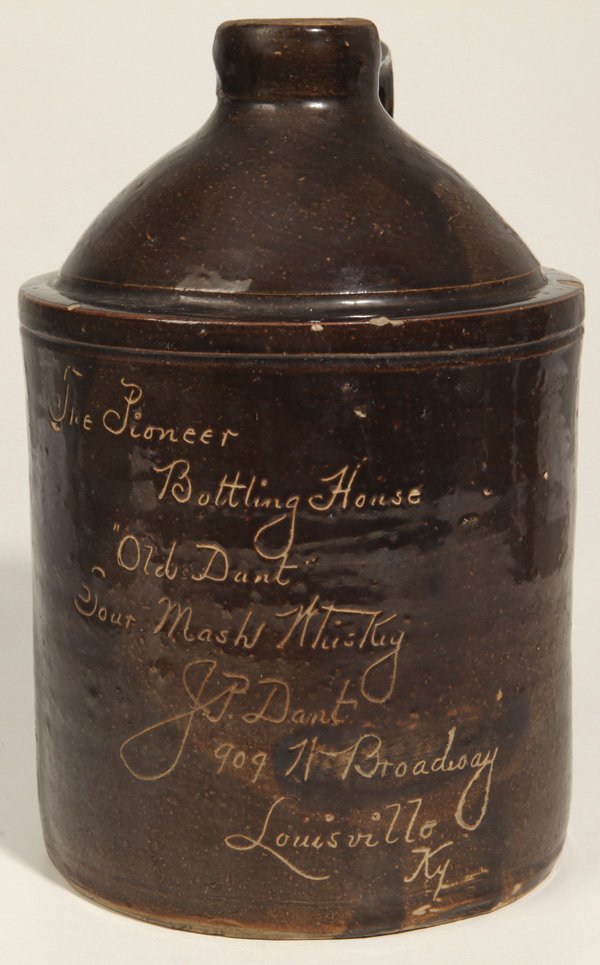 J. P. Dant Whiskey, Louisville, KY Stoneware Jug: Brown incised jug which reads, "The Pioneer Bottling House, "Old Dant" Sour Mash Whiskey. J. P. Dant, 909 Broadway, Lousiville, Ky." 10 3/4" High x 6 3/4" Diameter.