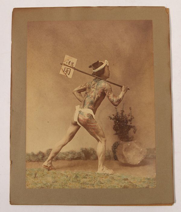 Felice Beato Albumen Photo of Japanese Man: This beautiful circa 1870 hand colored albumen photograph of a tattooed Japanese groom is 7.75 x 10 inches mounted on larger card stock, attributed to Felice Beato. Felice Beato (1832-1909) Italian/Br