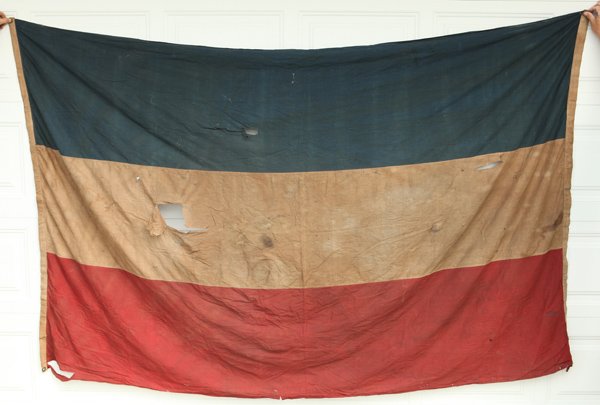 C. 1890's Netherlands Flag: This large (64 x 100 inch) flag in traditional horizontal tri-colors of red, white and blue, is somewhat unusual in that it has a canvas hoist at each end, each with two matching brass grommets. It is
