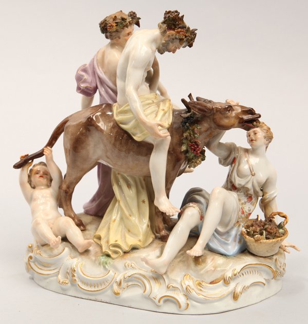 Meissen Figural Group: Depicting a Baccanal procession with man astride an ass, both with grape wreaths, around his head and the asses neck being lead by nearly nude younger male attendant with lightly draped young lady lyi