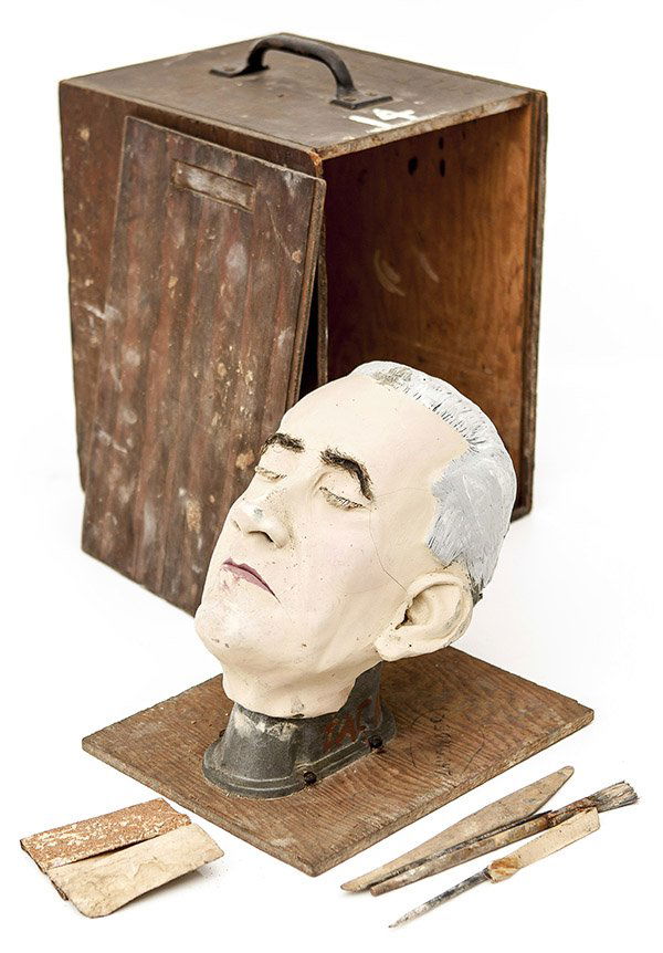 Morticians Model Head: A hand formed and painted head of a dead male with grey hair with real hair brows and lashes, mounted on metal and wood stand and in fitted wood box, circa 1930-40's. Head is circa 10" high, box is 10