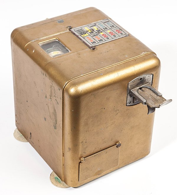 Coin-Op Trade Stimulator: In the form of a three wheel slot machine with stamped and colored winning combinations on nickeled steel plate on top that flips to cover window of wheels on top. In original gold painted finish with