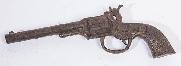 COLUMBIA CAST IRON CAP GUN: marked on left side "Columbia" an brown patina.d righ side "Pat. June/17 1890", 9" long with nice all-over