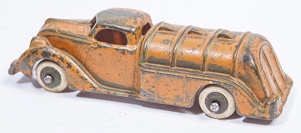 CAST IRON GASOLINE TRUCK: in original orange painted finish with white rubber tires on turned wooden rims, 1 3/4 x 5 1/2 x 1 1/2" high.