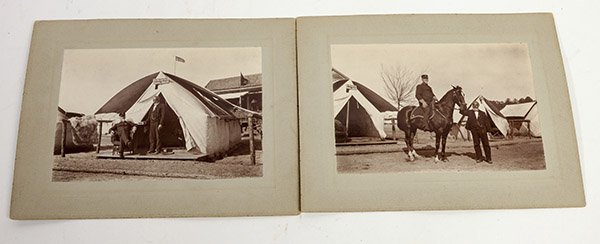 Two Photos of General Nelson Cole: A 4 Â½ x 6 Â¾ inch silver gelatin photograph on original larger card stock mount showing Cole seated in front of his tent with an African American man servant holding a box of cigar for him. Sign 