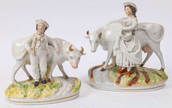 Pair Thomas Parr Staffordshire Figures: Milk Maid & Cow Herd, each on painted oval bases and with polychrome painted features, 9 x 4 1/2 x 9 1/2" & 4 x 7 1/2 x 8 1/2" high.