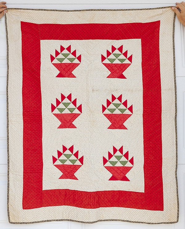 Early Pieced Crib Quilt: with six flower baskets in solid red and green calico fabrics on white & black calico ground with bold red border, all hand quilted, circa 1870's, 39 x 50".