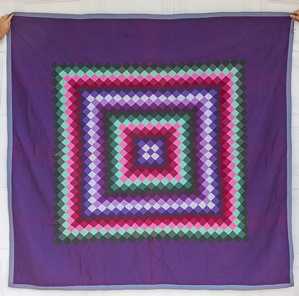 Fine Pieced Amish Quilt: in 12 different solid colors, with classic wide border, winter quilt made with heavy fabric and all hand quilted, 76 x 80".