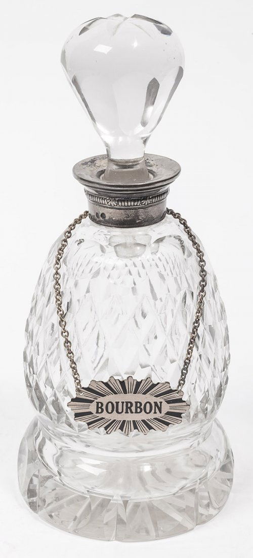 Sterling & Cut Glass Decanter: a fine footed cut glass decanter with original cut stopper and silver collar with two French type hall marks, saw-tooth cut body, cut starburst on base and stopper, 9" high, circa 1890-1910.