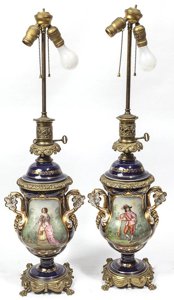 Pair Bronze Mounted Old Pair Porcelain Oil Lamps: each with fine hand painted garden scene of young French lady and cavalier. She his holding bunch of flowers and fan in yellow and pink gown, he is dressed in red wearing plumed hat and sword. Cobalt