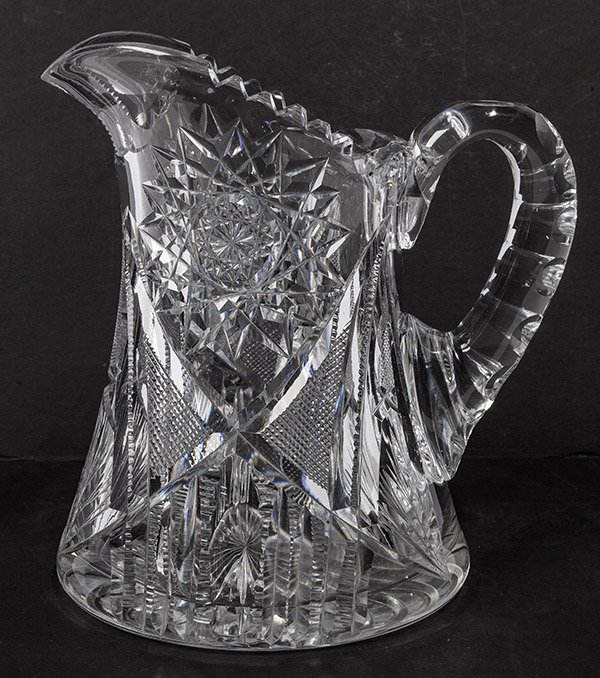 Brilliant Period American Cut Glass Pitcher: with hob star, nail head, fan and ladder cutting on body, coin spot cut handle and star burst base with saw tooth lip, 6 1/2" diameter at base x 8 3/4" high