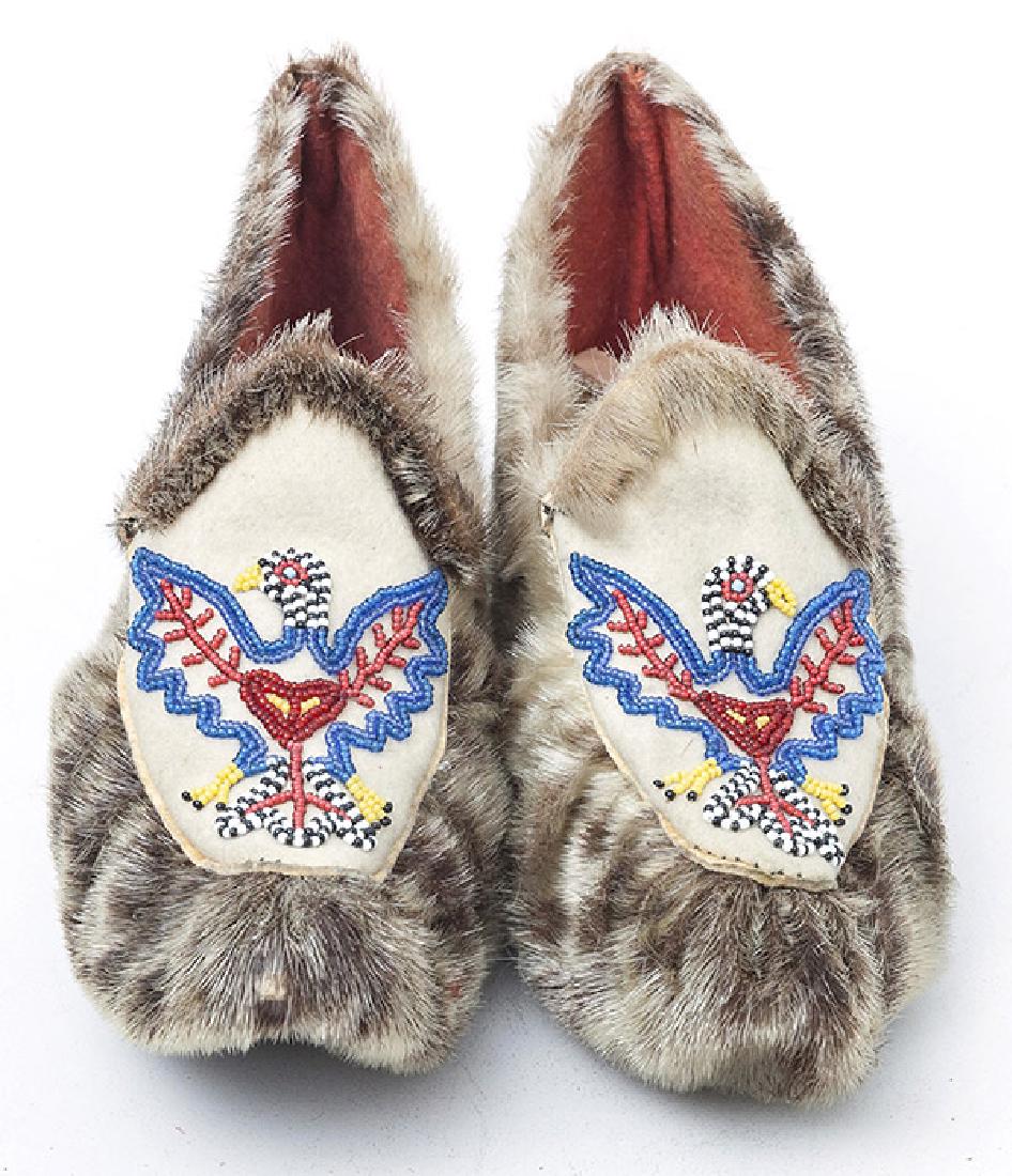 Eskimo Seal Skin & Beaded Moccosins: 2nd half of the 20th century, adult size with spread winged eagle in polychrome beadwork. 10" long.