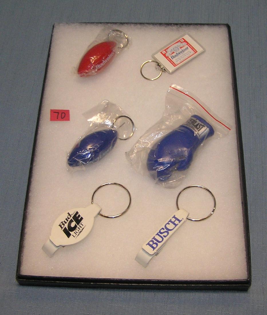 Collection of vintage beer promotional key chains: Collection of vintage beer promotional key chains includes Budweiser est. value $30.00-$40.00
