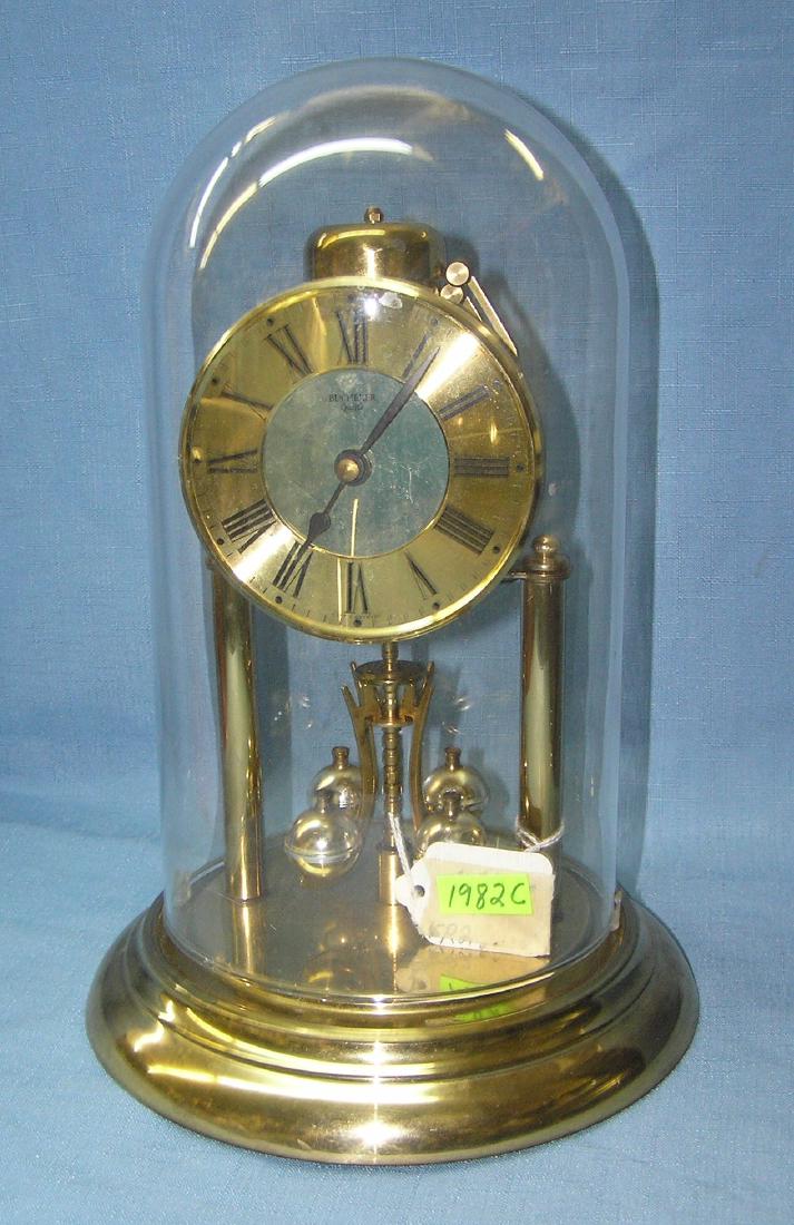 Bucherer quartz brass and glass dome clock: Bucherer quartz brass and glass dome clock made in Germany est. value $100.00-$125.00