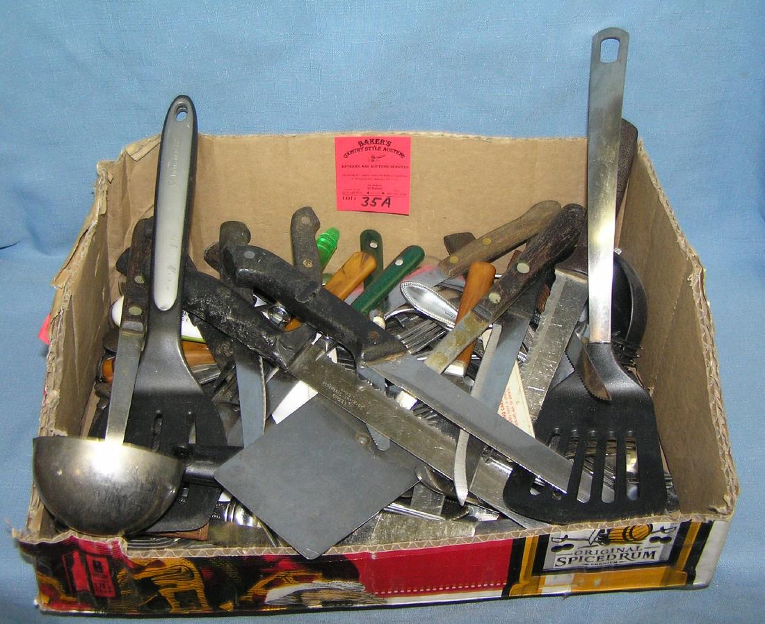 Large box full of estate silverware and kitchenwares: Large box full of estate silverware and kitchenwares includes many quality steak and cutting knives, ladles, spatulas and all forms of silverware est. value $40.00-$60.00