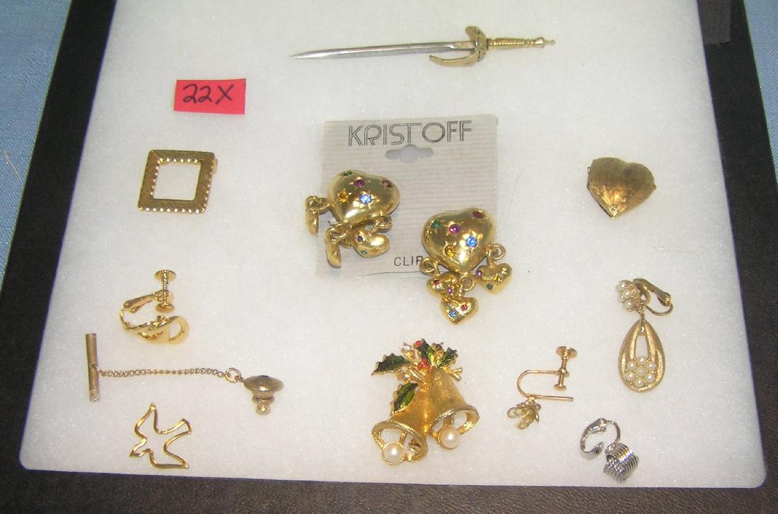 Group of vintage costume jewelry: Group of vintage costume jewelry includes earrings, pins, heart shaped locket and more est. value $35.00-$40.00