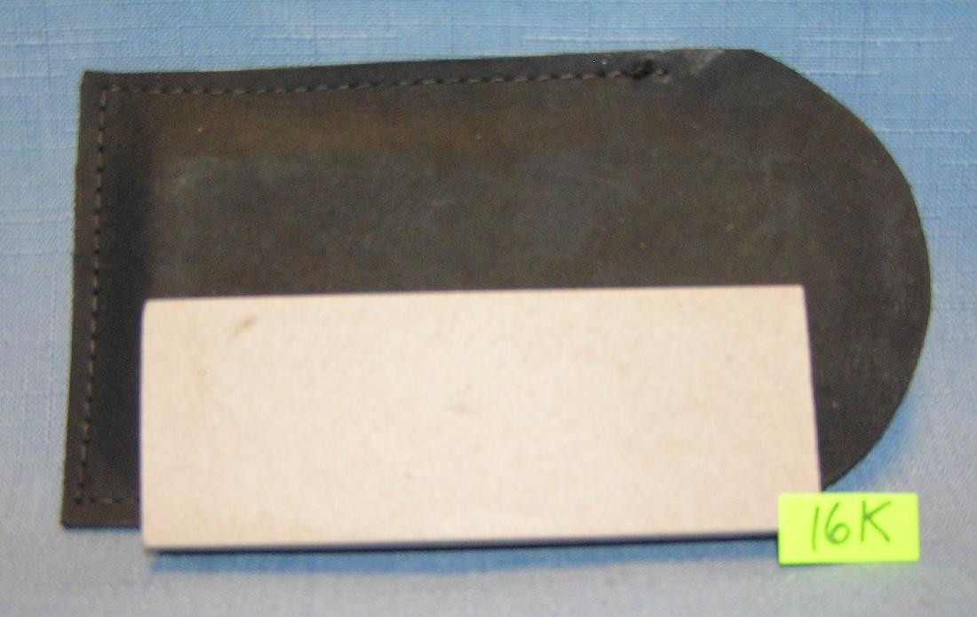 Genuine oil stone knife sharpening stone: Genuine oil stone knife sharpening stone with hand stitched case est. value $30.00-$35.00