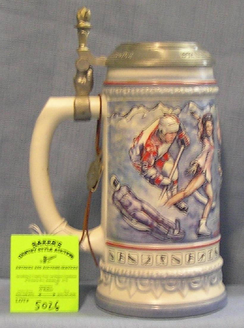 Vintage US Winter Olympic games Team beer stein: Vintage 1992 US Winter Olympic games Team beer stein from Albertville France. Stein made in Germany with pewter cover with USA and Olympic rings upper thumb opener features the Olympic torch mint cond