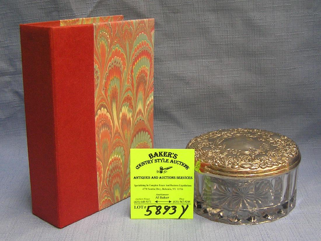 Pair of jewelry/trinket cases: Pair of jewelry/trinket cases includes metal covered glass container and a book shaped box est. value $35.00-$40.00