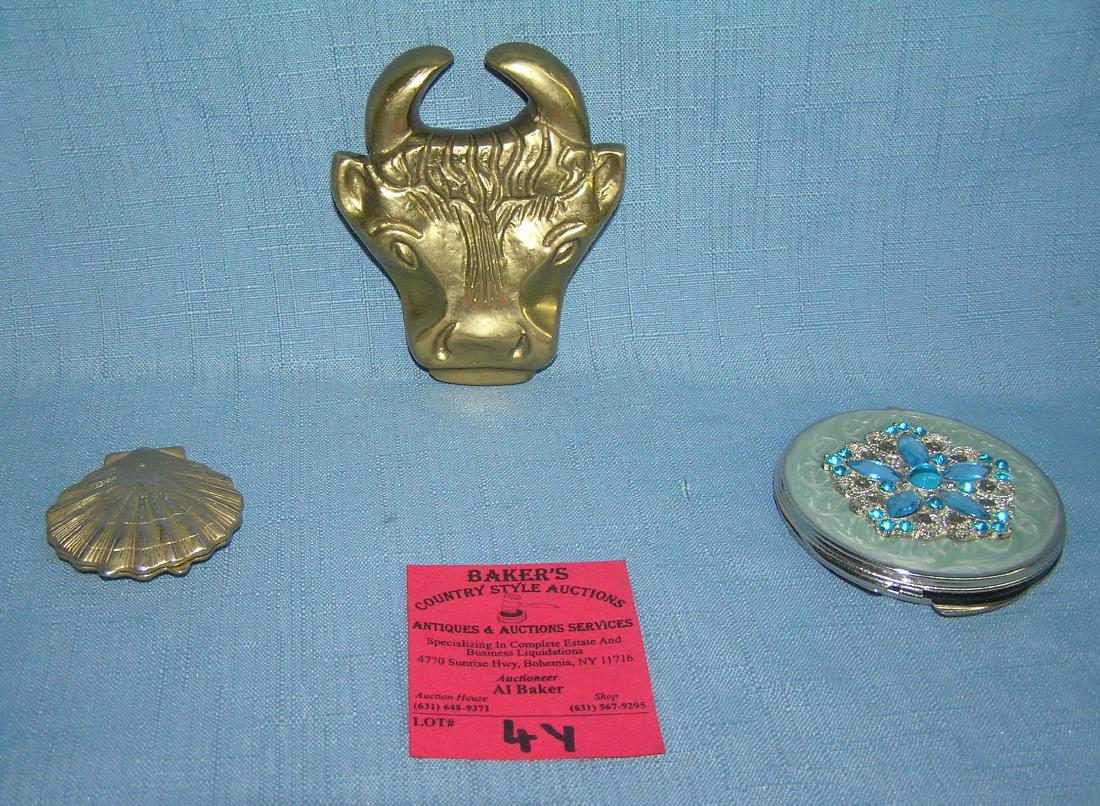 Pair of quality make up compacts and paper weight: Pair of quality make up compacts and a solid brass bull and bear double sided Wall St paper weight/bottle opener est. value $50.00-$60.00