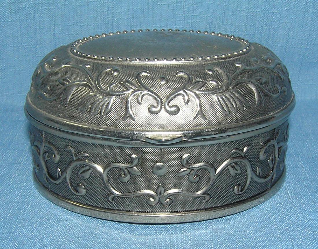 Oval shaped decorated cast metal jewelry box: Oval shaped decorated cast metal jewelry box est. value $30.00-$35.00