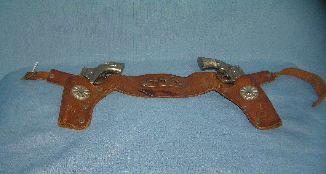 Pair of Hubley cast metal toy cap guns: Pair of Hubley cast metal toy cap guns with leather holster, great early leather holster with Hubley TEX and Hubley PET est value $75.00-$80.00