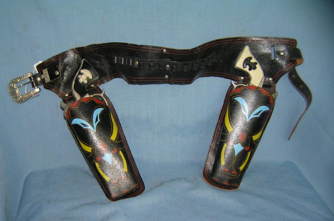 Hop Along Cassidy cap guns and holster set: Pair of vintage Hop Along Cassidy cap guns and holster set circa 1950's est value $275.00-$300.00