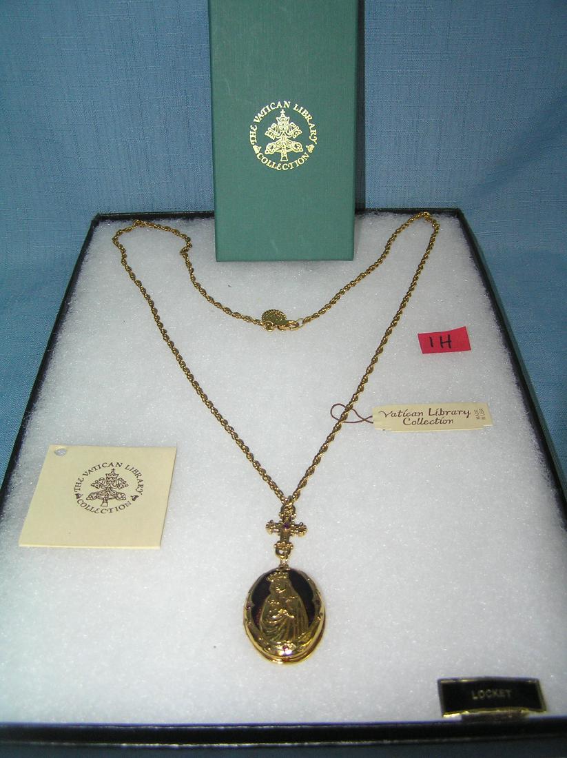 Gold toned Blessed Mother necklace with locket: Gold toned Blessed Mother necklace with locket from the original Vatican Library collection with original box and paper work est. value $175.00-$200.00