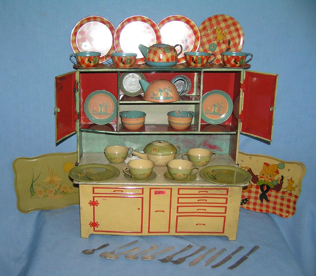 Antique child's hoosier baking cabinet: Antique child's hoosier baking cabinet all tin 44 pieces by Wolverine Co. and Ohio Art all circa 1930's est. value $275.00-$300.00