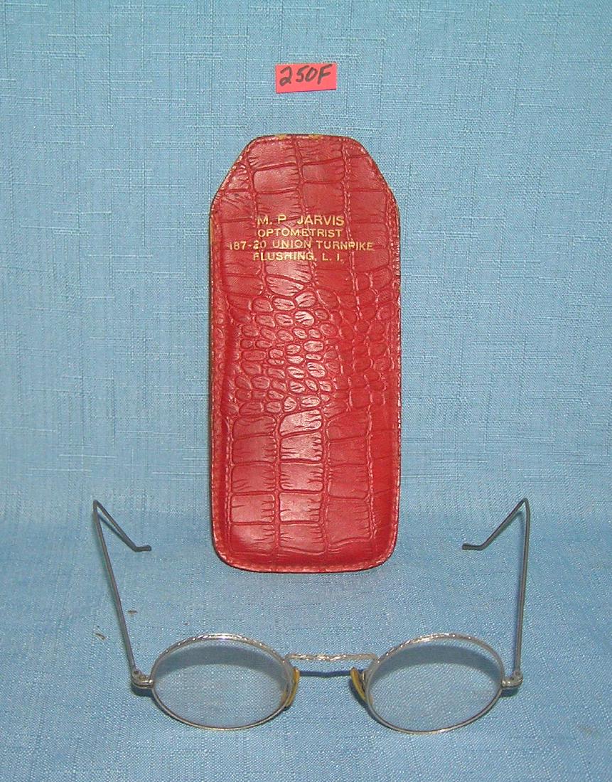 Antique eyeglasses with fancy silver style frames: Antique eyeglasses with fancy silver style frames and a Flushing Long Island advertising case est. value $40.00-$50.00