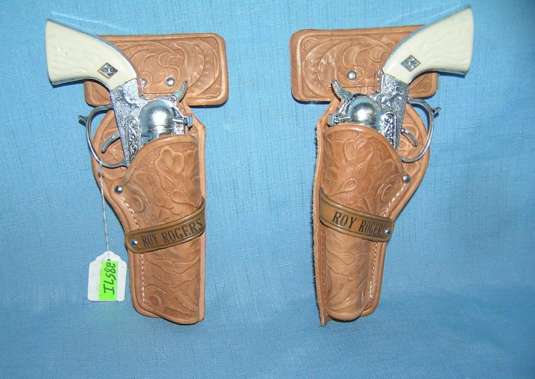 Roy Rogers Cast metal cap guns with holster: Pair Of Roy Rogers Cast metal cap guns with holster est. value $75.00-$80.00