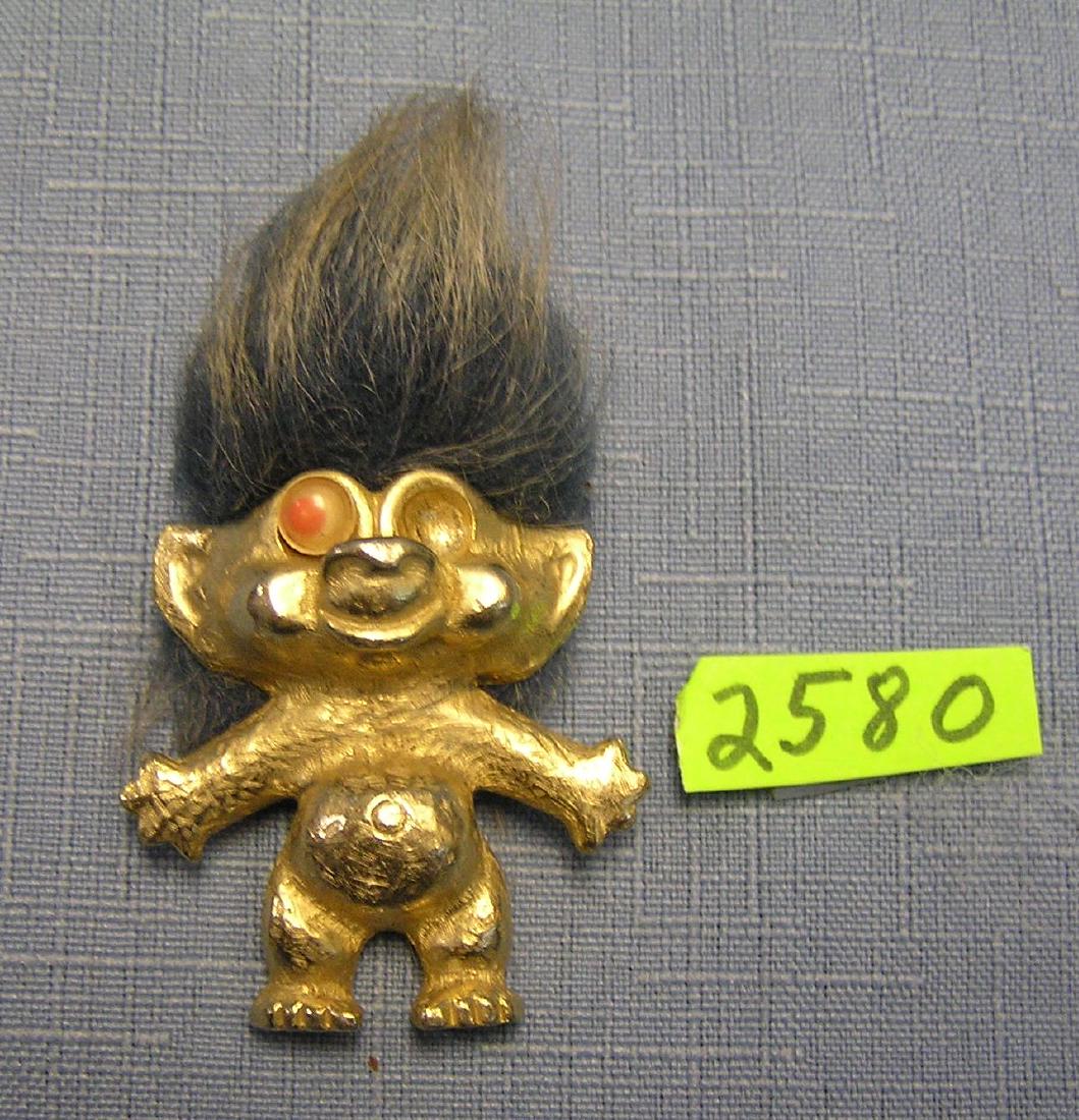 Early all cast metal googily eyed figural troll pin: Early all cast metal googily eyed figural troll pin, marked on back Pan C63, 1 eye as found, overall good, scarce est. value $65.00-$75.00
