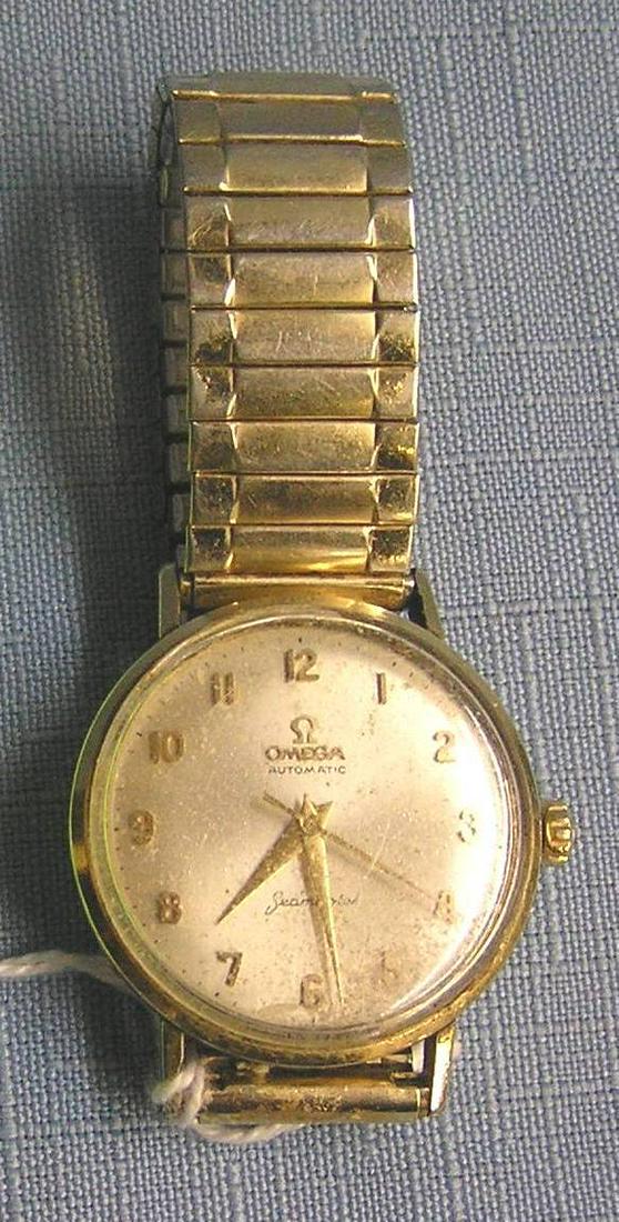 Early Omega Seamaster gentleman's wrist watch: Early Omega Seamaster automatic Swiss made gentleman's wrist watch, case appears to be gold or gold filled, band is marked Speidel USA, this circa 1950's watch is in excellent working condition est. v