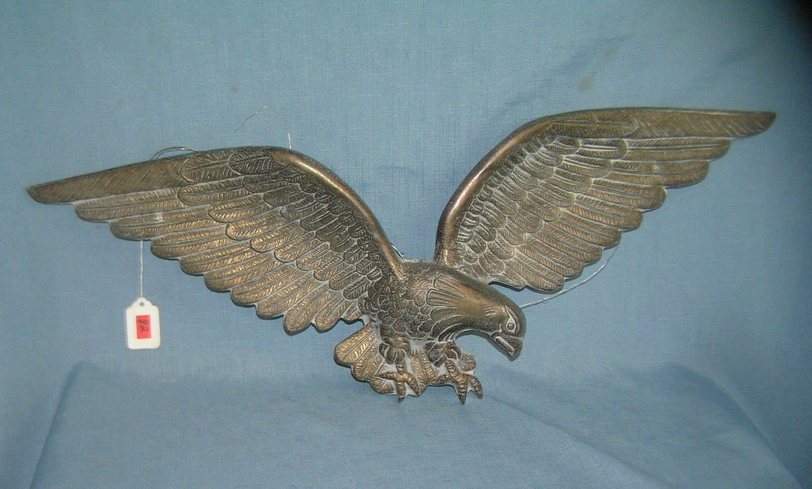 Heavy cast metal American eagle wall display: Heavy cast metal American eagle wall display 8 1/2 inches high 24 inch wing span est. value $50.00-$60.00