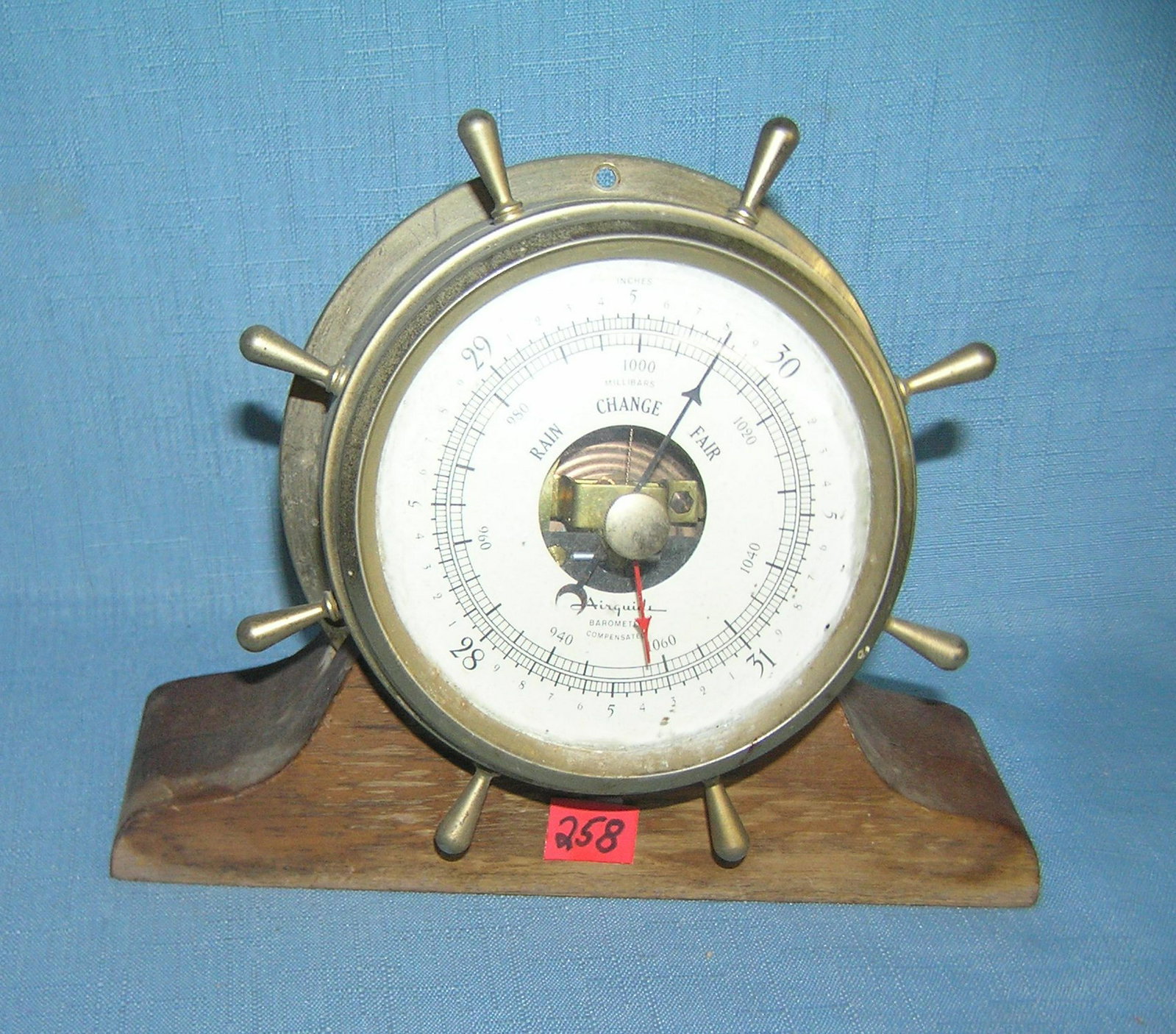 Ship's wheel barometer heavy brass with wood stand: Ship's wheel barometer heavy brass with wood stand est. value $60.00-$75.00